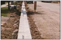 newly installed curb beside a paved street