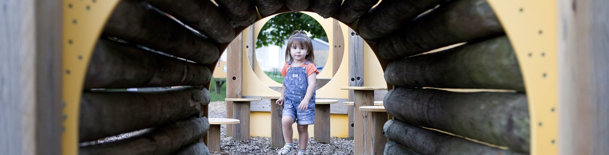 little girl inside tunnel at cheese park