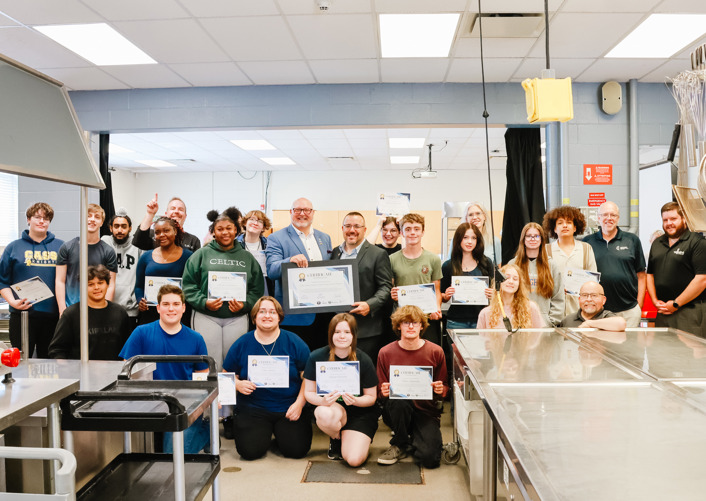 Class holding their certificates with Community Leaders.