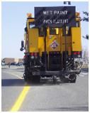line painting truck making yellow lines on a paved road